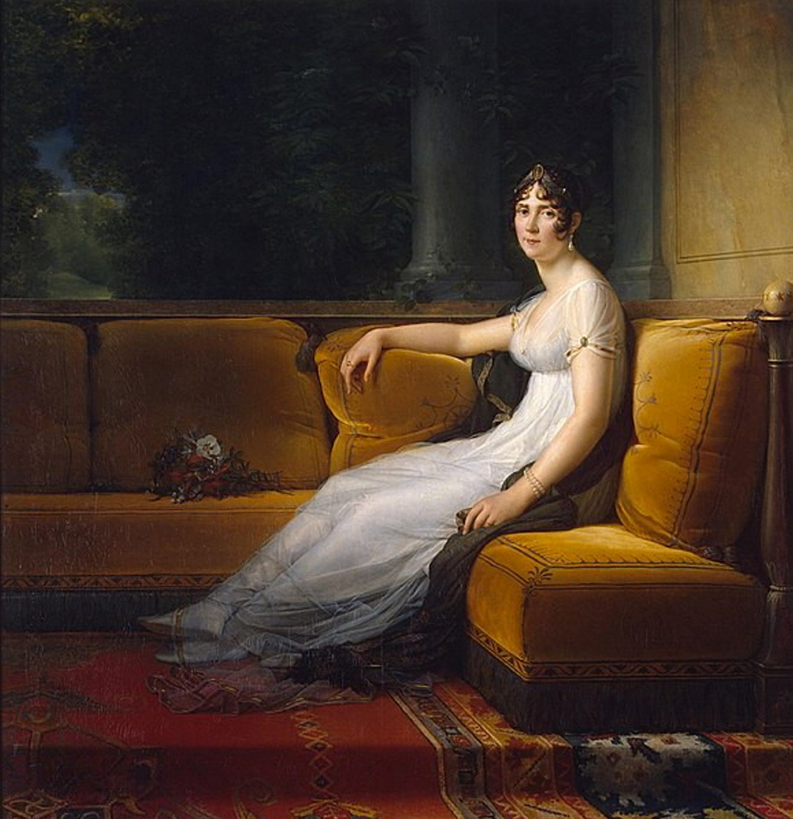 portrait of Portrait of Josephine de Beauharnais (Empress Josephine) where she is sitting on a couch with her legs stretched out and a bunch of flowers sitting next to her.