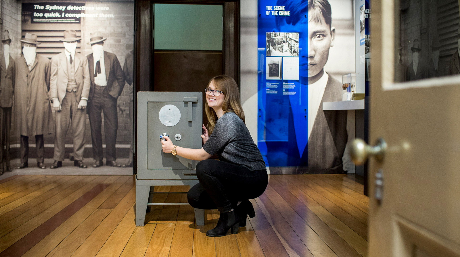 A woman trying to open a safe at the Justice and Police Museum