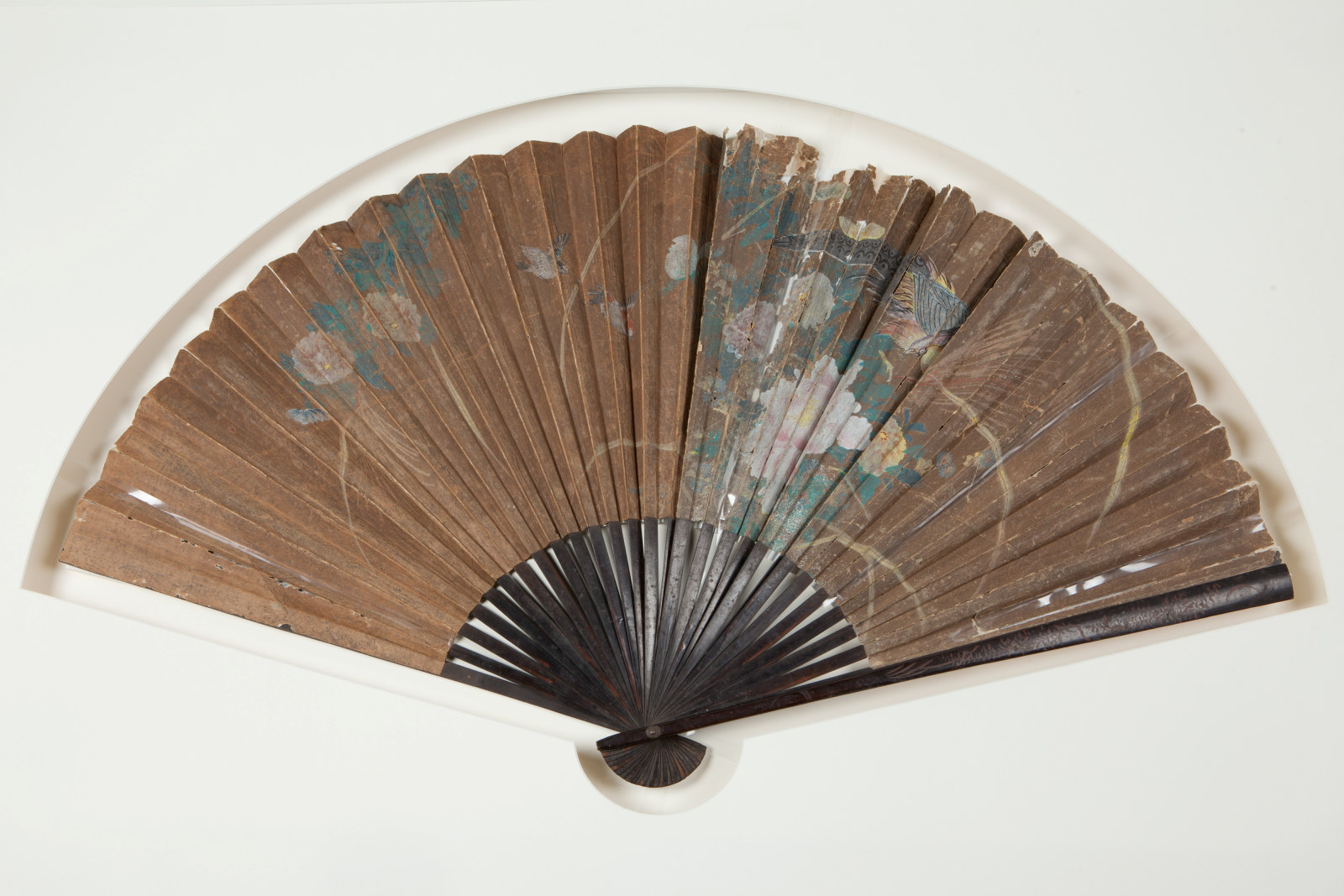 Large pleated paper fan with a handpainted floral and bird design, circa 19th century