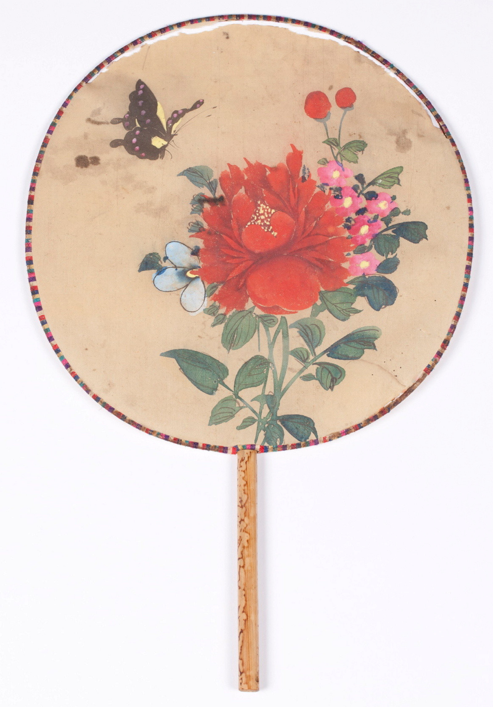 Fixed blade fan of painted silk and bamboo. Likely Japanese, and pre-1939.