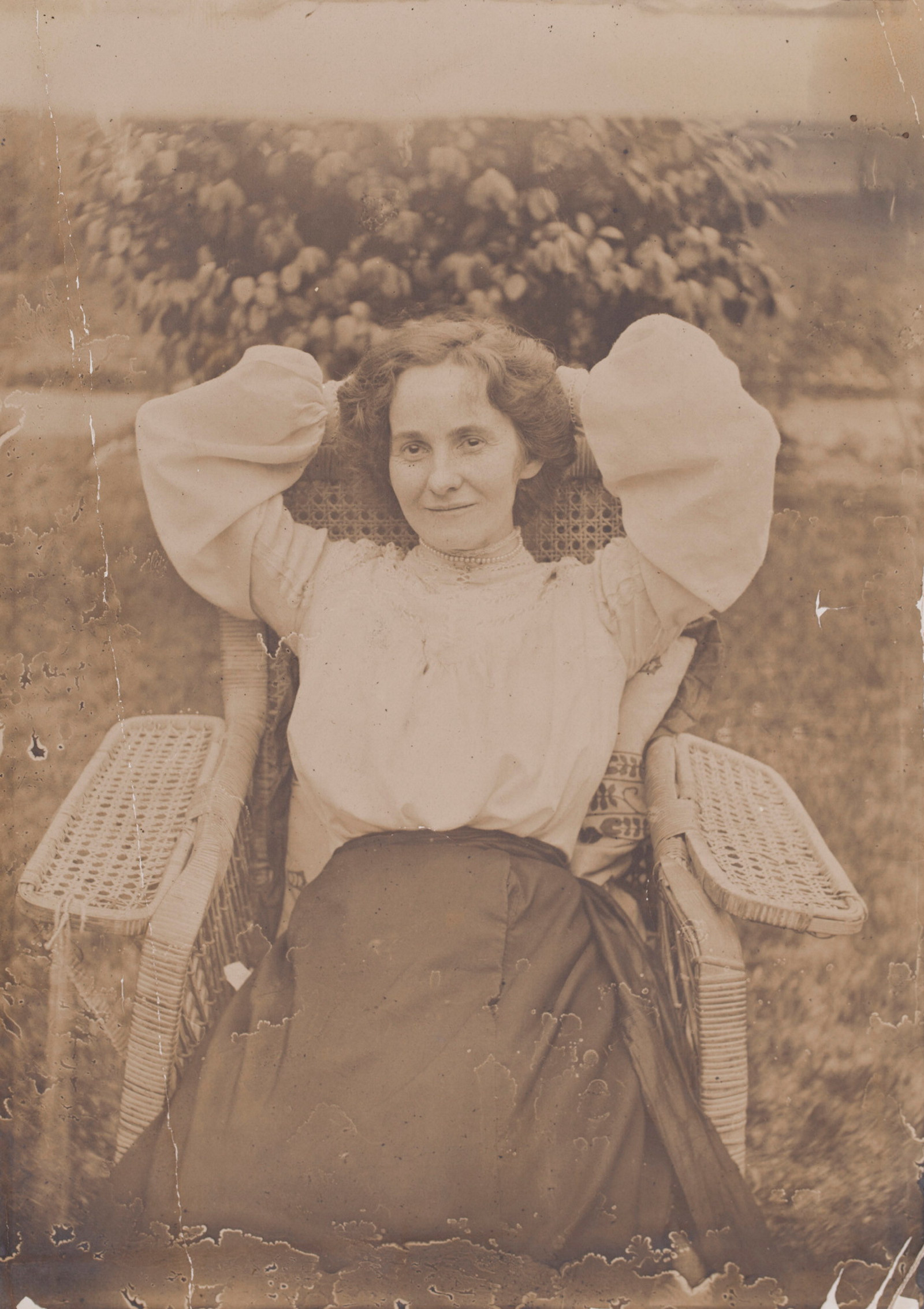 Tot Thorburn at ease in a cane armchair in the garden at Meroogal, around 1905