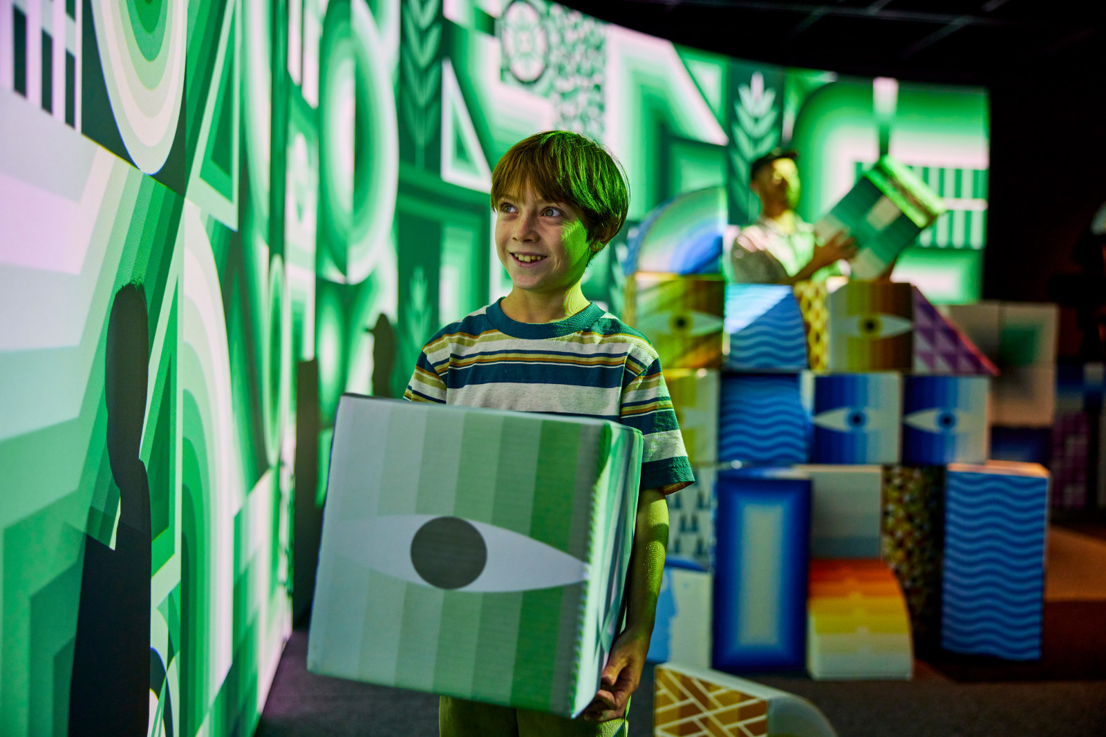 A visitor watching the digital illustrations at PlayScapes at the Museum of Sydney