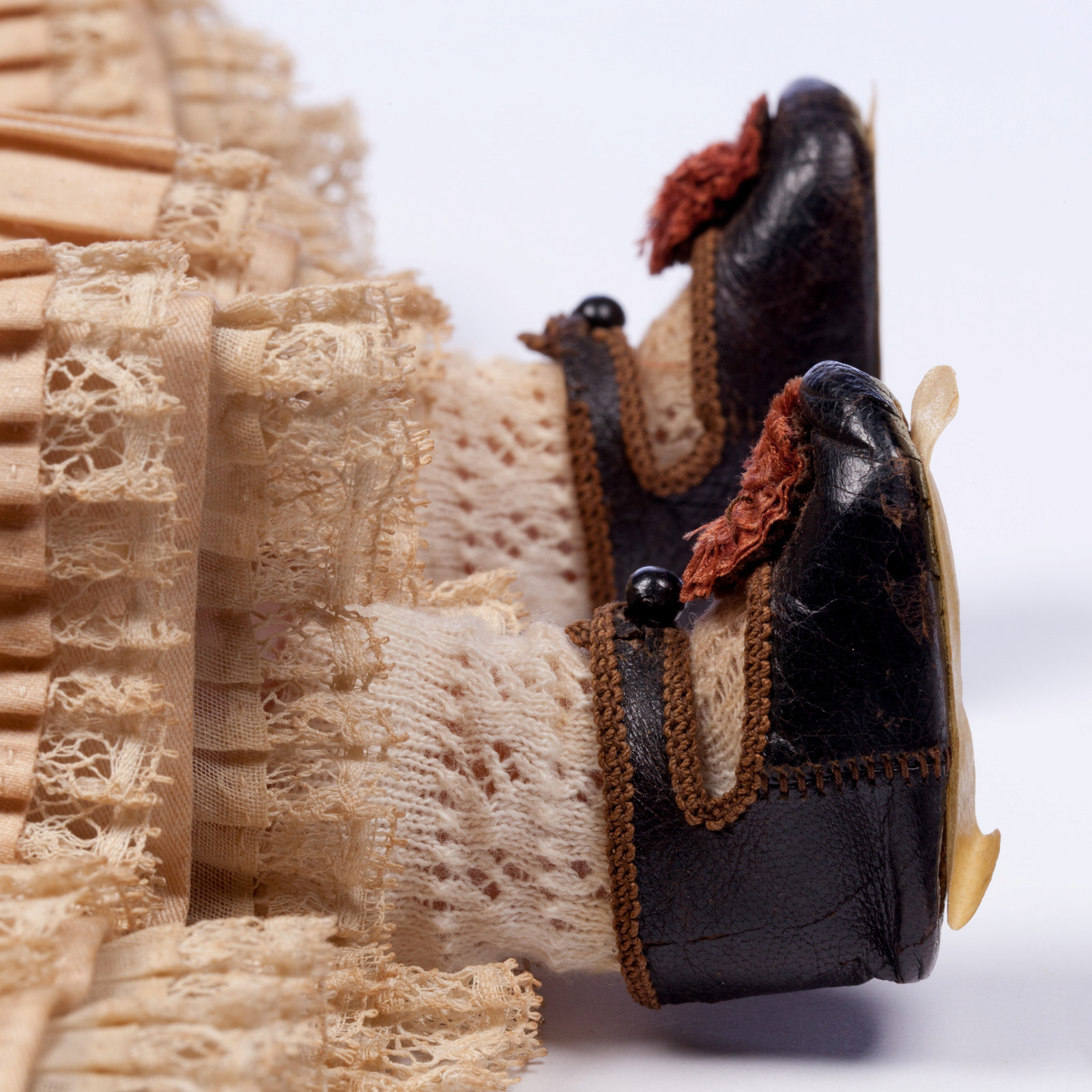 Shoes and dress (detail) of a wax doll named Charlotte, 1853