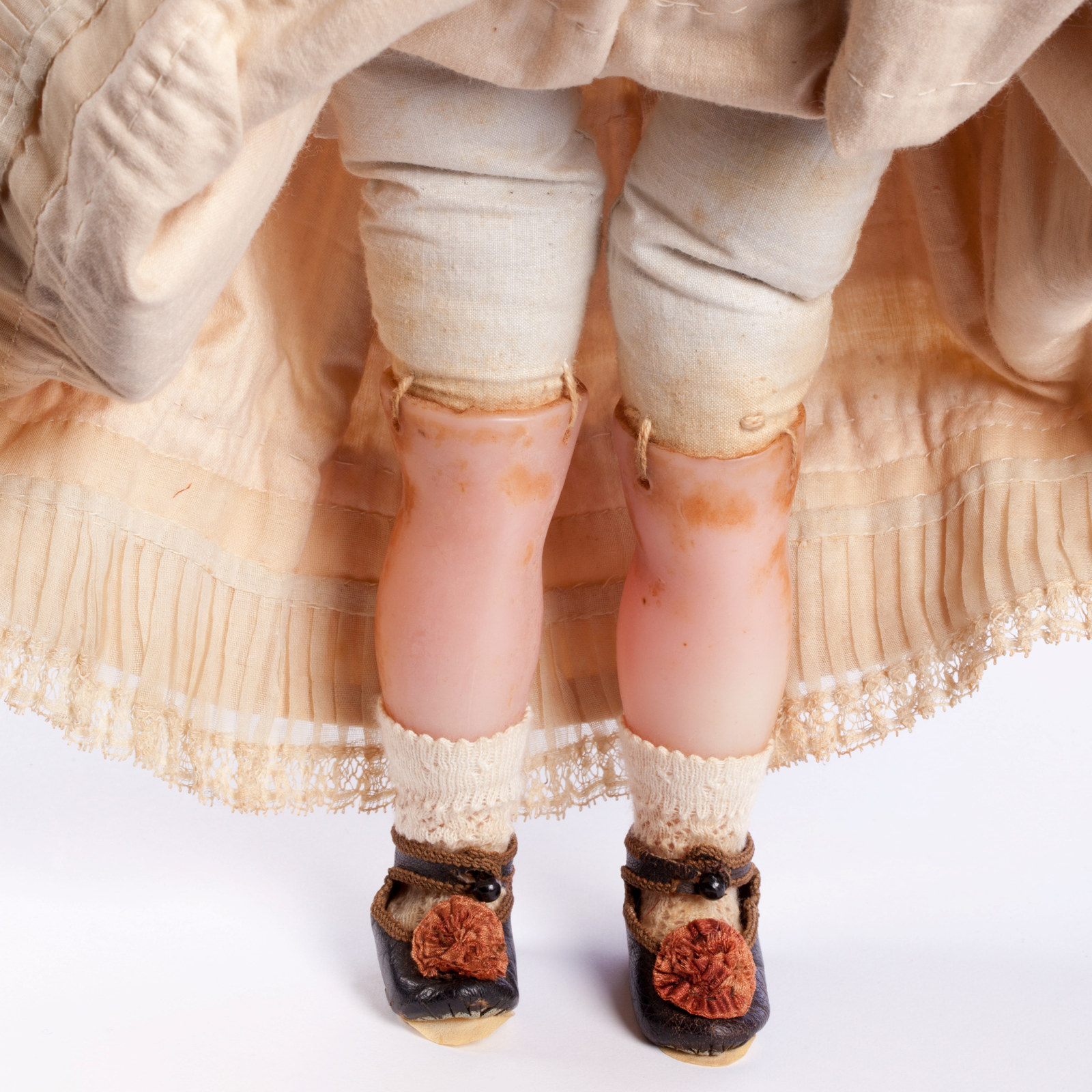 Legs, shoes and dress (detail) of a wax doll named Charlotte, 1853