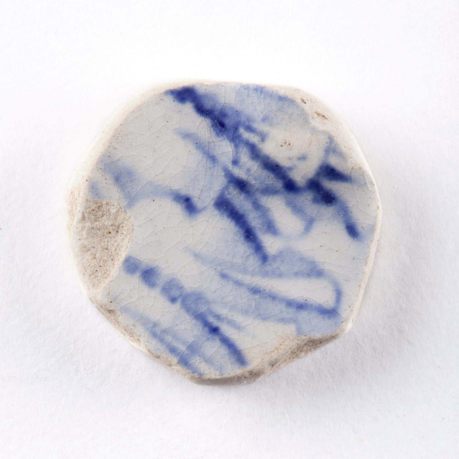 Ceramic game piece found underfloor at Hyde Park Barracks during archaeological excavations