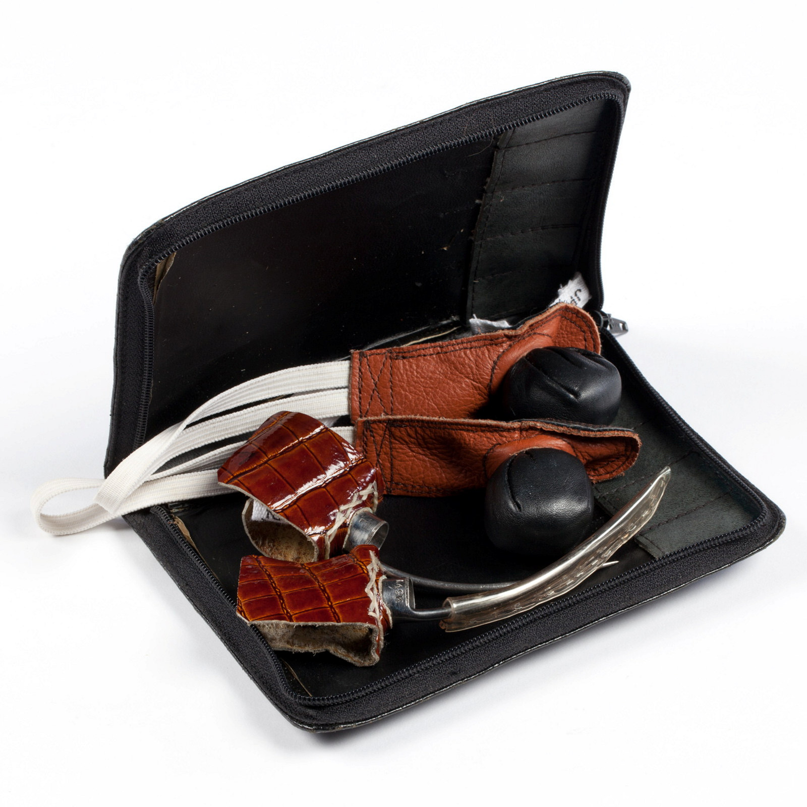 Black leather wallet containing cock fighting spurs and pads, date unknown
