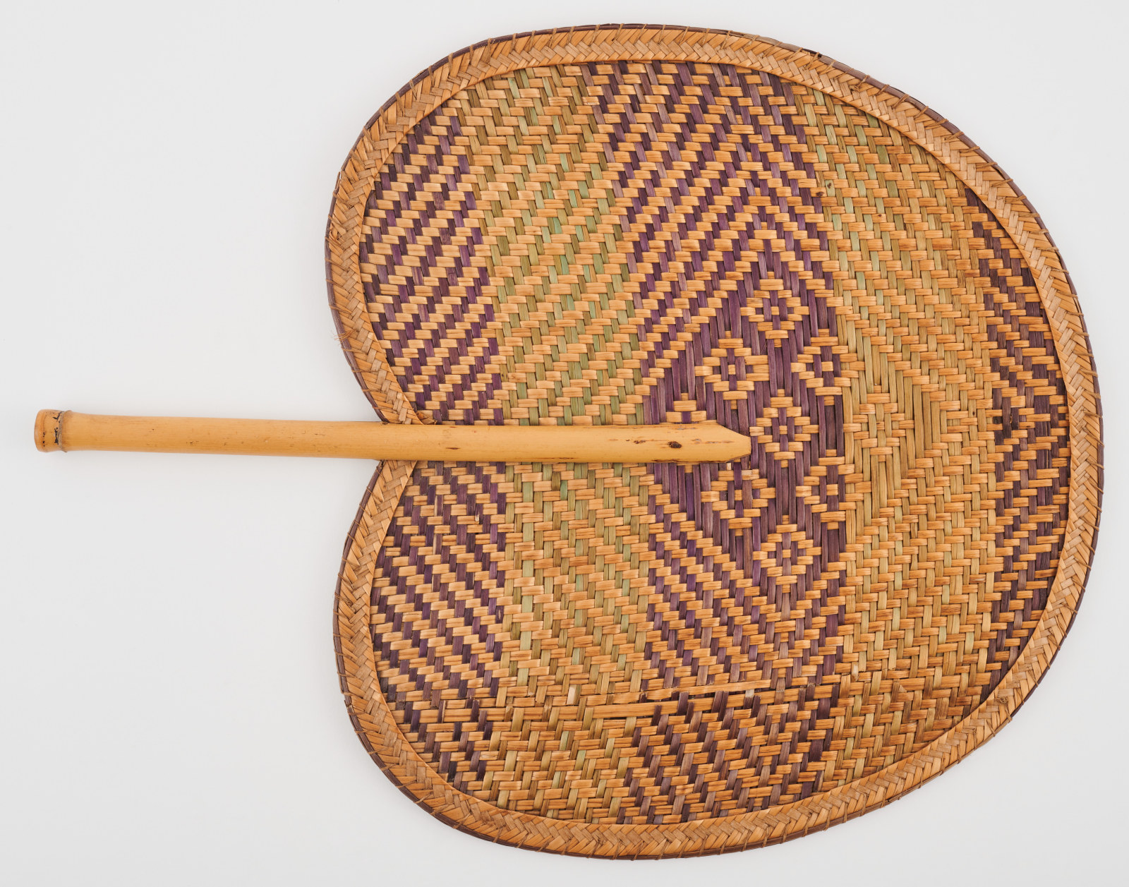 Woven handheld fan owned by Esther Moran, a resident of No 60 Gloucester Street, maker unknown, date unknown, palm leaf and bamboo