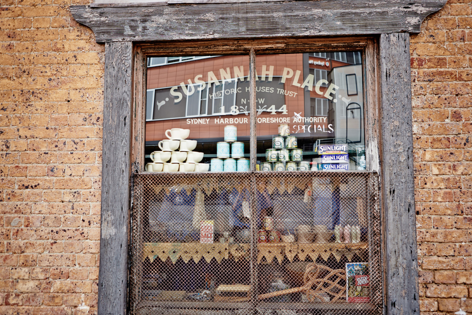 Goods in the window of the corner shop, 64 Gloucester Street, Susannah Place Museum