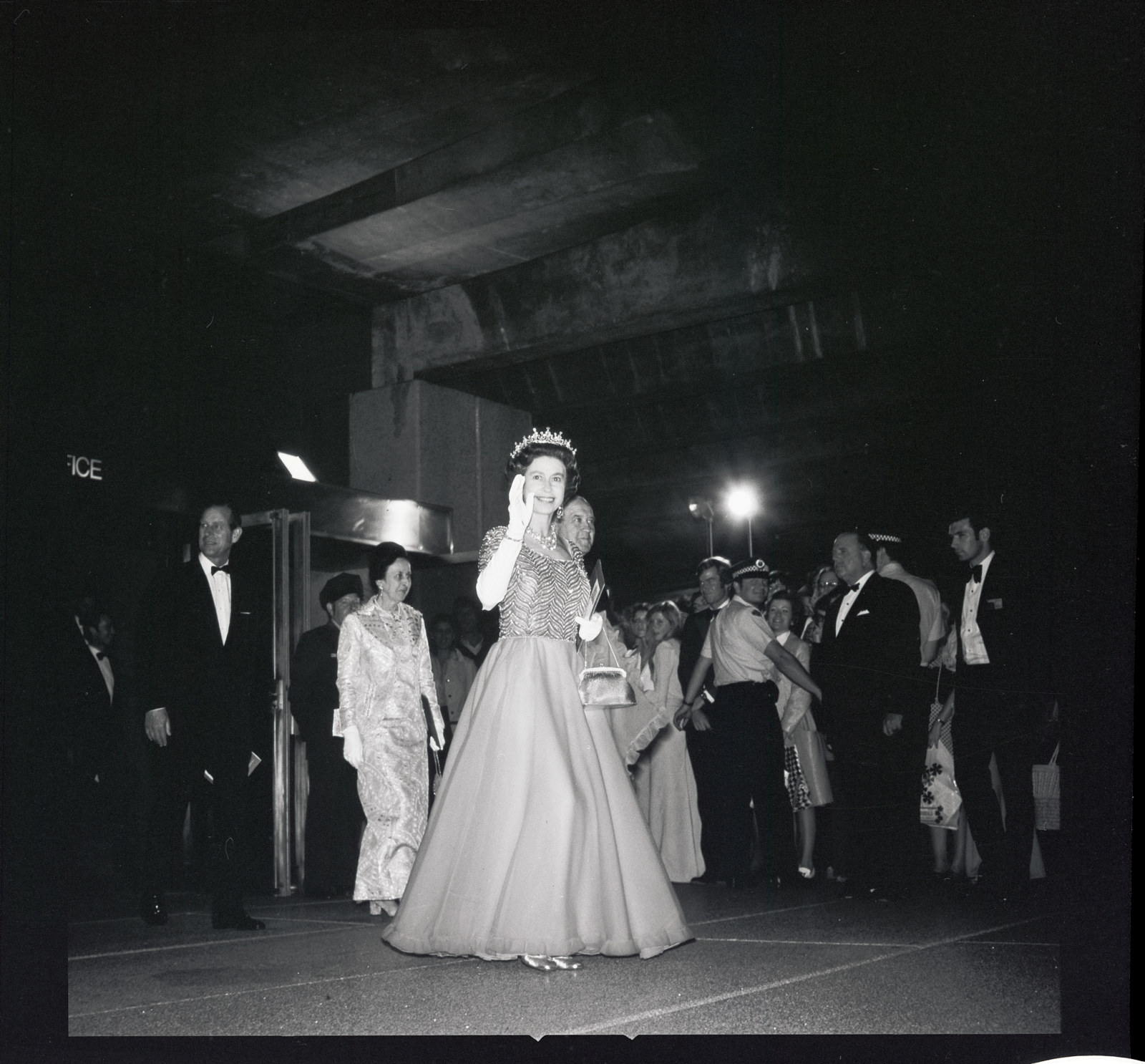 The Queen and official party departing the Opera House after the performance of The Magic Flute by the Australian Opera, Monday 22nd October 1973 [L – R Sir Asher Joel, Lady Mollie Askin, HM the Queen carrying a souvenir programme, Premier Robert Askin].