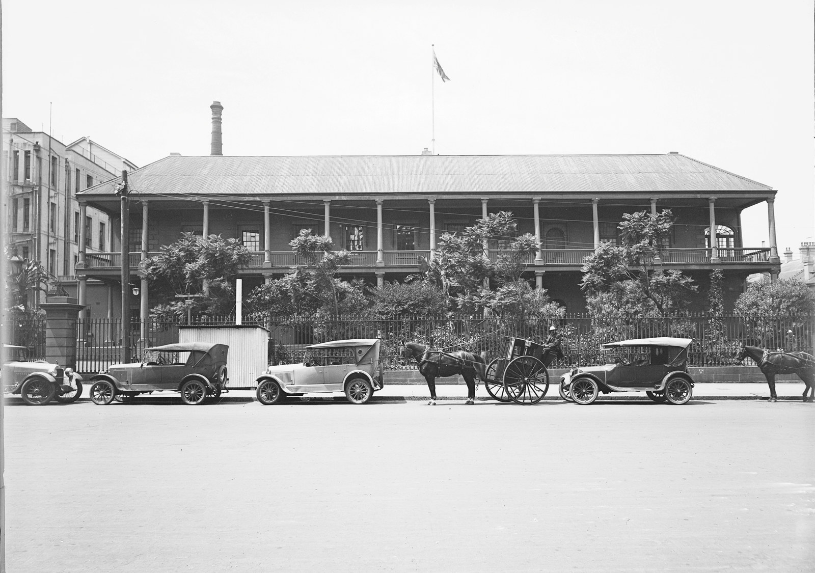 Cars and horses and carriages outside the Sydney Branch Royal Mint, Macquarie Street, c1926