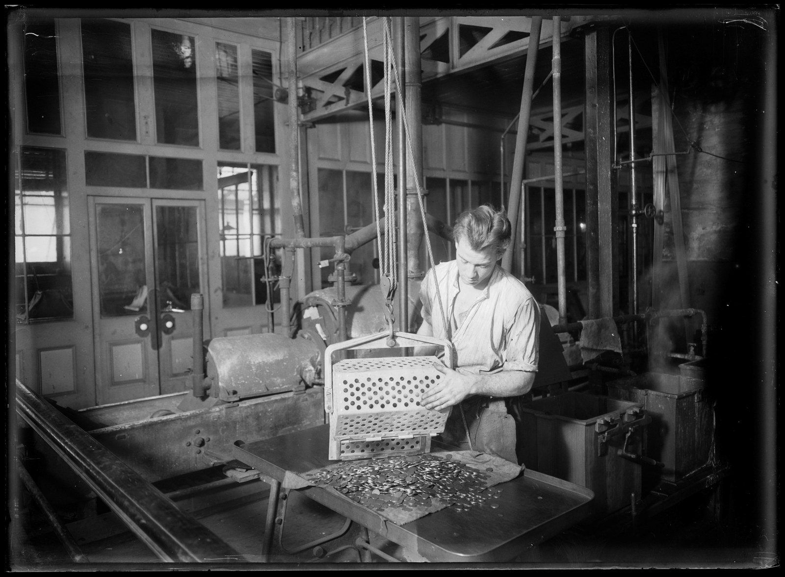 Workman in the coining factory at the Sydney Mint, June 1926 