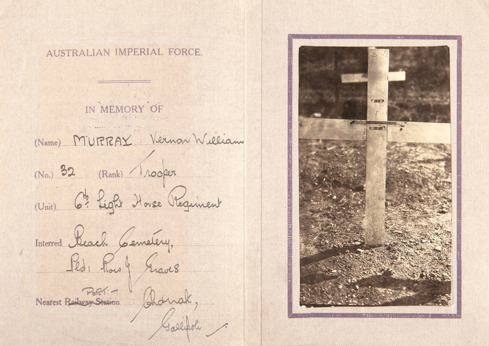 Open booklet with handwriting on left page and photo of grave marker on right.