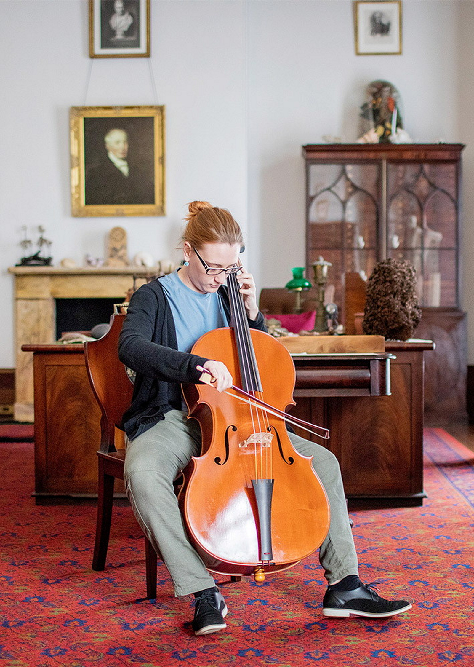 Jemma Thrussell from the Historical Performance Unit, Sydney Conservatorium of Music, playing cello in the library, Elizabeth Bay House