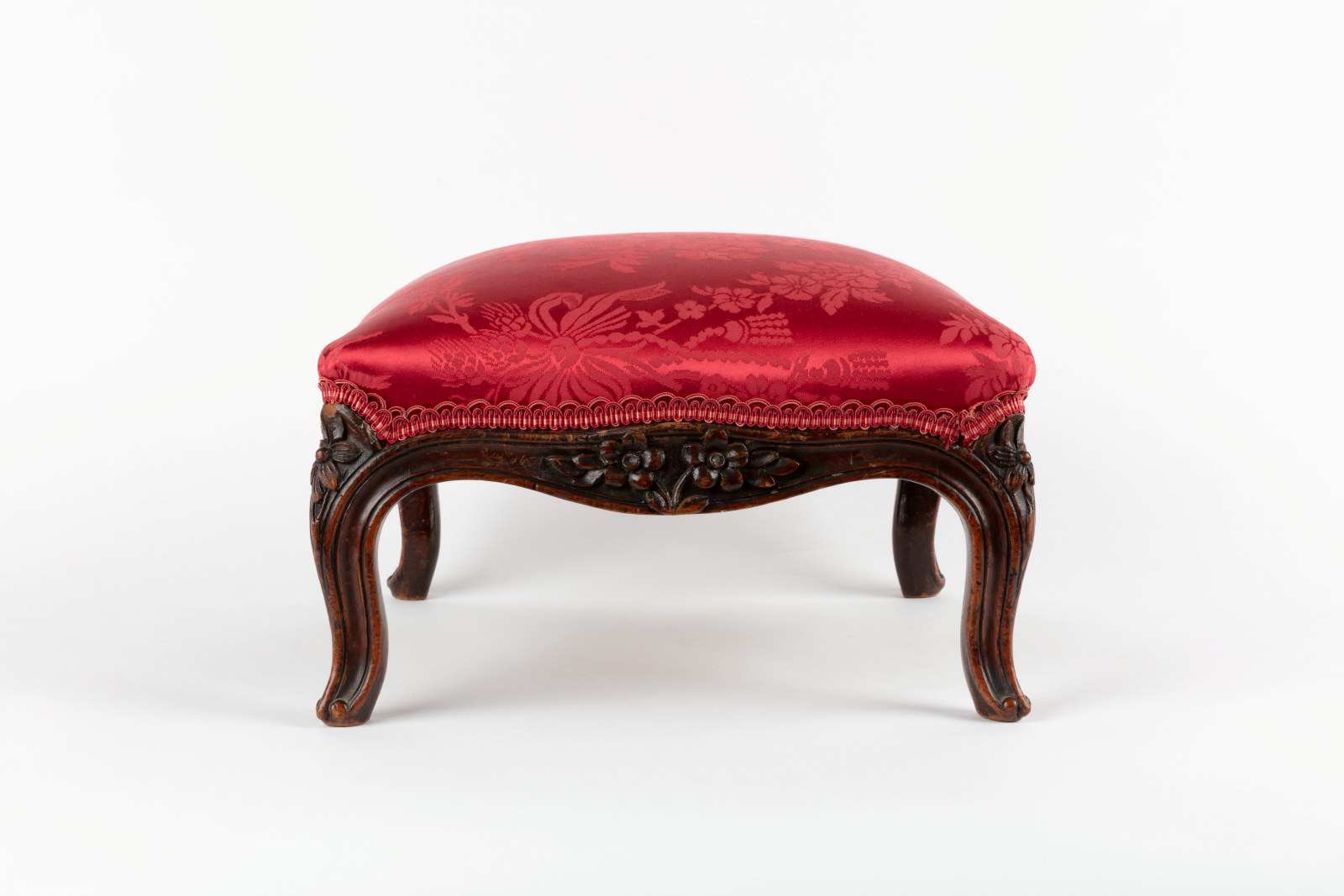 Upholstered footstool, maker unknown, England, circa 1850, rosewood and crimson silk damask