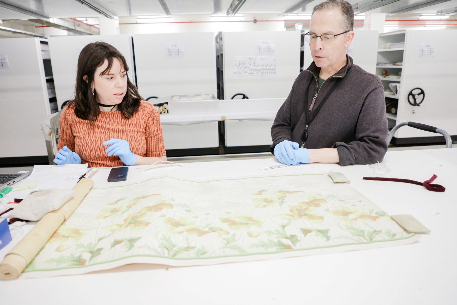 Alex Shapley and Michael Lech view a wallpaper from the John and Phyllis Murphy collection, Museums Discovery Centre