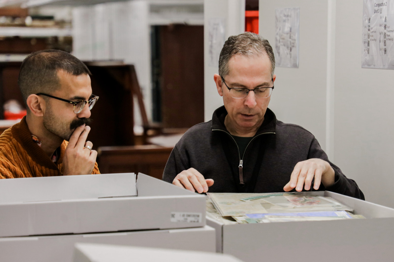 Aaron de Souza and Michael Lech assess the John and Phyllis Murphy collection, Museums Discovery Centre